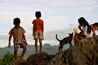 Children and the temple cat waiting for sunset